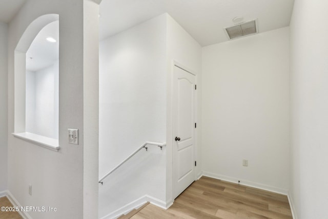 corridor with light hardwood / wood-style floors