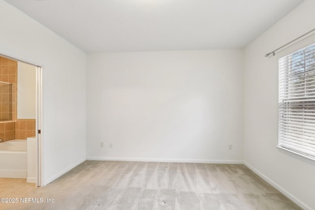 spare room with light colored carpet