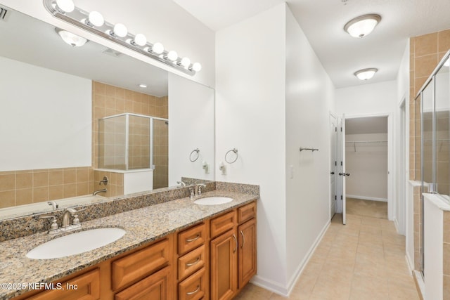 bathroom with vanity, tile patterned floors, and a shower with door