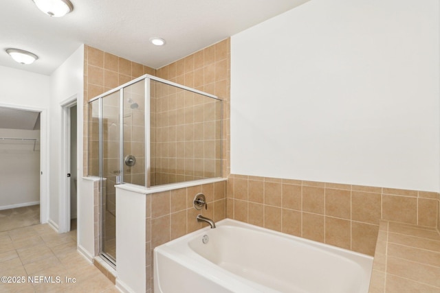 bathroom featuring shower with separate bathtub and tile patterned flooring