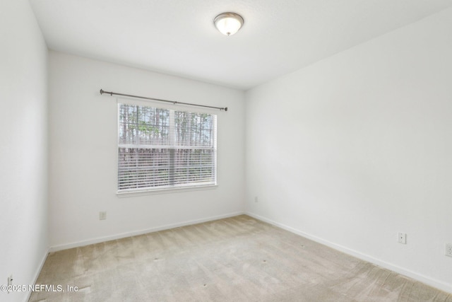 empty room featuring light carpet