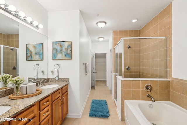 bathroom with independent shower and bath, tile patterned flooring, and vanity