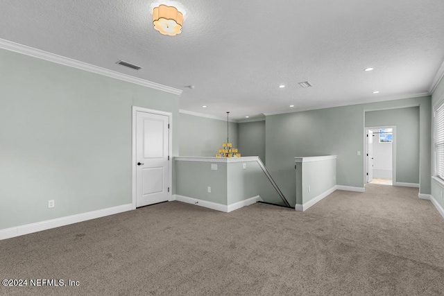 empty room with carpet flooring, ornamental molding, and a textured ceiling