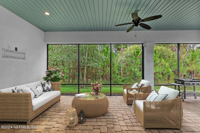 sunroom featuring ceiling fan