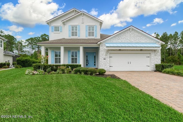 view of front of property featuring a garage and a front yard