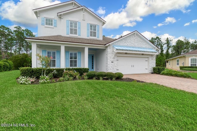 view of front of property featuring a front yard and a garage