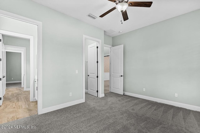 unfurnished bedroom with ceiling fan and light colored carpet