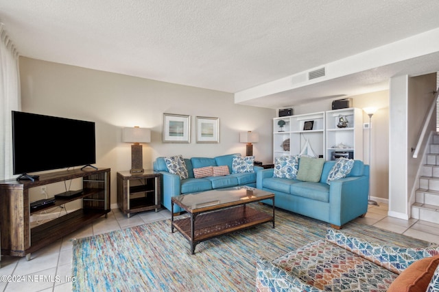 living room with light tile patterned floors and a textured ceiling