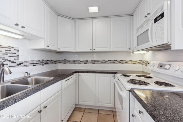 kitchen with sink, white cabinets, white appliances, decorative backsplash, and light tile patterned floors