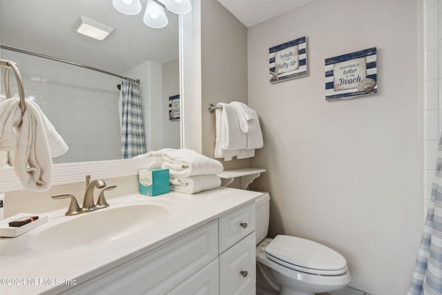 bathroom with a shower with curtain, vanity, toilet, and a textured ceiling