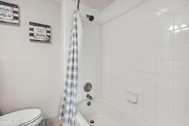 bathroom featuring toilet and shower / bath combo with shower curtain