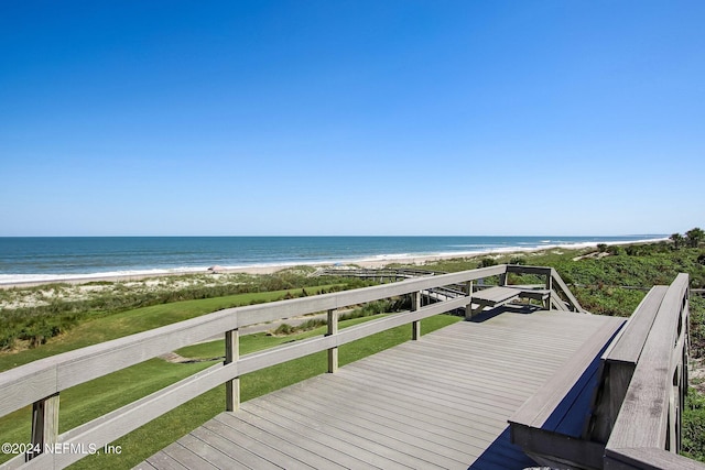 wooden terrace featuring a view of the beach and a water view