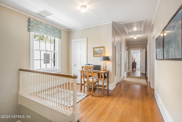 hall with light wood-type flooring and crown molding