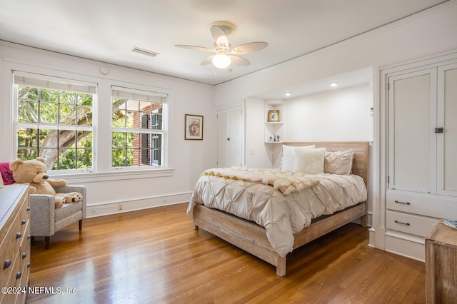 bedroom with wood-type flooring and ceiling fan