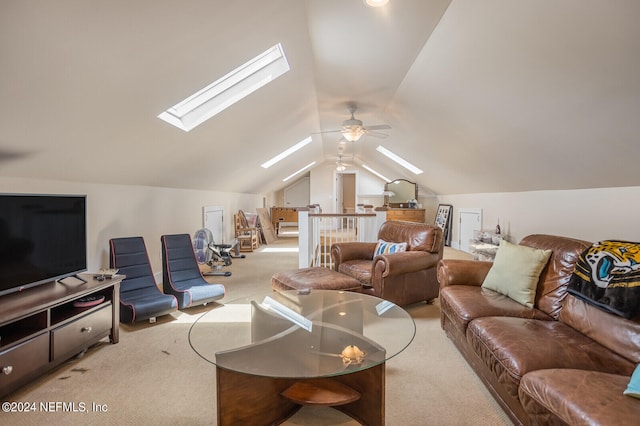 living room with ceiling fan, carpet flooring, and lofted ceiling with skylight