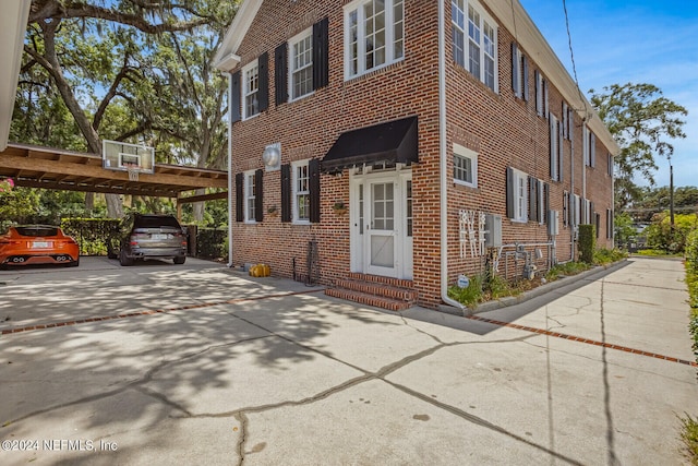 view of side of home with a carport