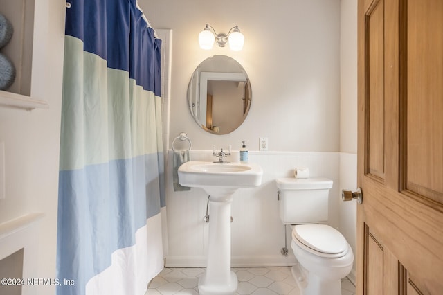 bathroom featuring tile floors and toilet