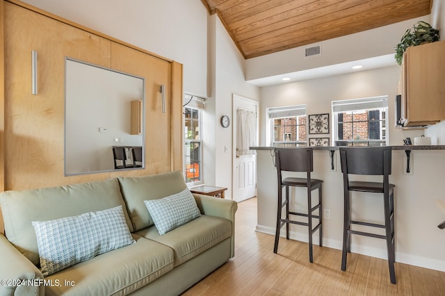 living room with high vaulted ceiling, light hardwood / wood-style floors, and wood ceiling