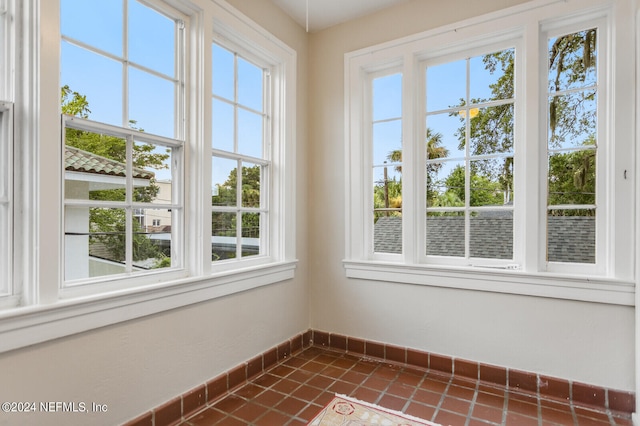 unfurnished sunroom with a wealth of natural light