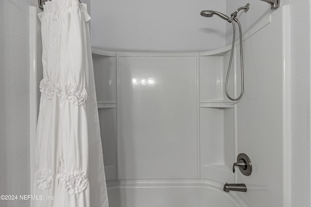 bathroom with shower / bath combo with shower curtain