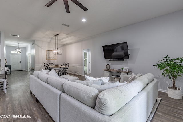 living room with ceiling fan with notable chandelier and dark wood-type flooring