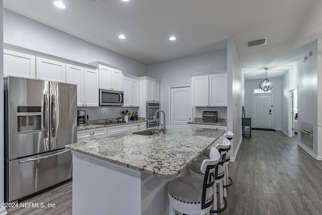 kitchen featuring sink, white cabinetry, dark hardwood / wood-style floors, and stainless steel appliances