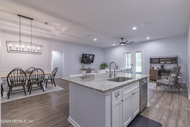 kitchen featuring ceiling fan with notable chandelier, hardwood / wood-style flooring, sink, and pendant lighting