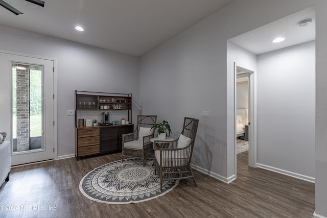 sitting room with dark wood-type flooring