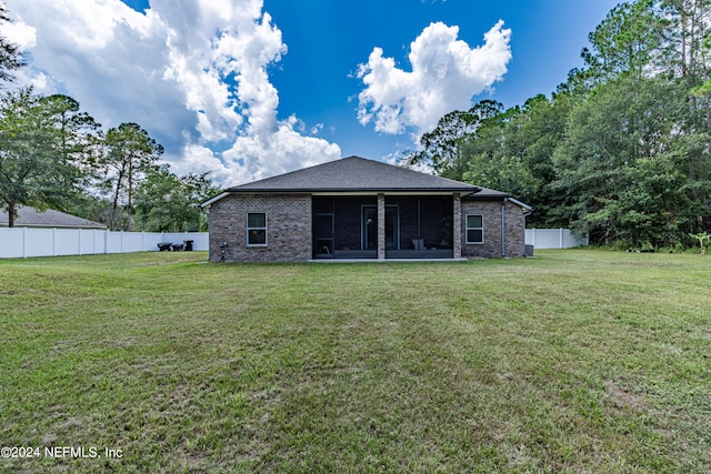 back of property featuring a yard