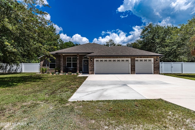 view of front of property featuring a garage and a front yard