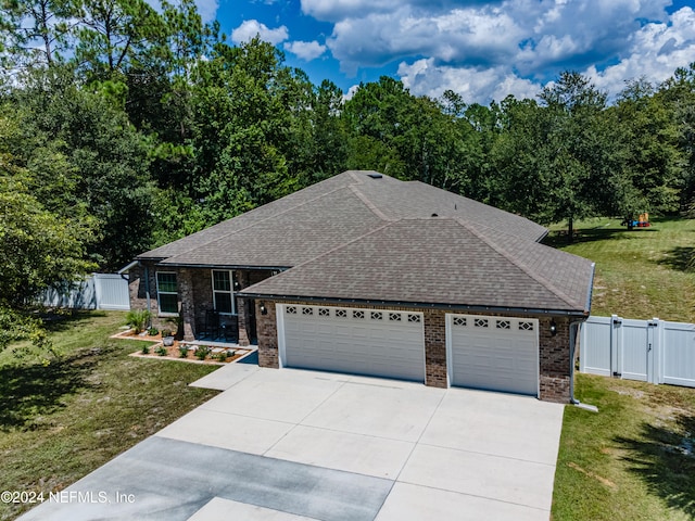 view of front of property with a front yard and a garage