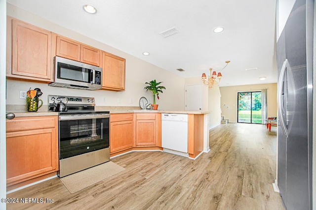 kitchen featuring stainless steel appliances, light wood-type flooring, and kitchen peninsula