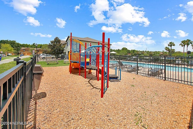 view of playground featuring a community pool