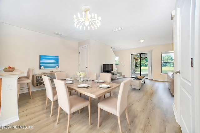 dining room with an inviting chandelier and light hardwood / wood-style floors