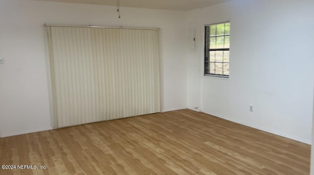 empty room with light wood-style floors and baseboards