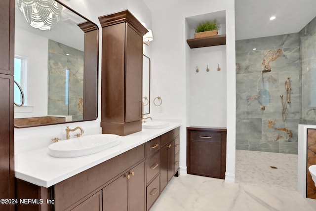 bathroom with vanity and a tile shower