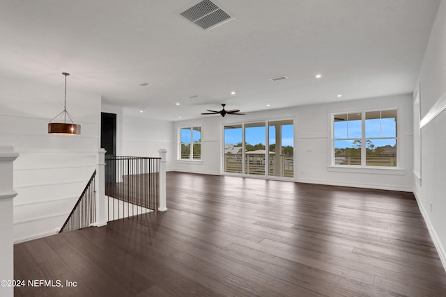 unfurnished living room featuring ceiling fan and dark hardwood / wood-style floors