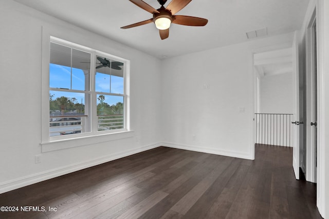 spare room with ceiling fan and dark hardwood / wood-style floors