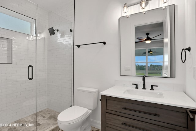 bathroom with ceiling fan, a shower with shower door, vanity, and toilet