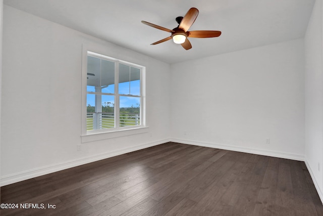 unfurnished room with ceiling fan and dark hardwood / wood-style flooring