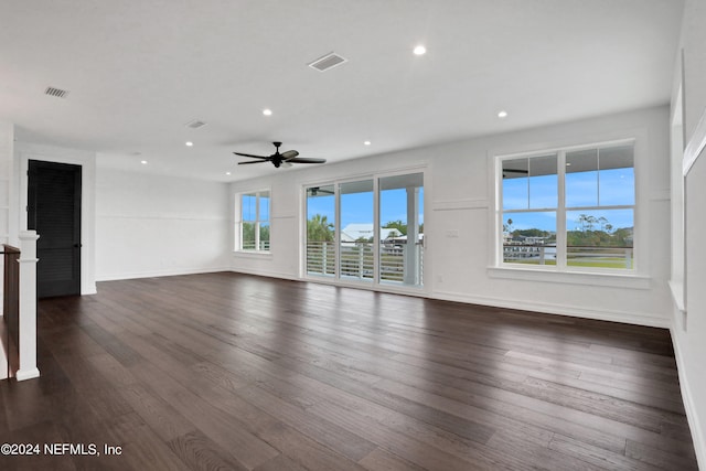 unfurnished living room with ceiling fan and dark hardwood / wood-style flooring