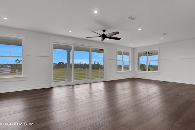 interior space featuring dark wood-type flooring, ceiling fan, and a healthy amount of sunlight