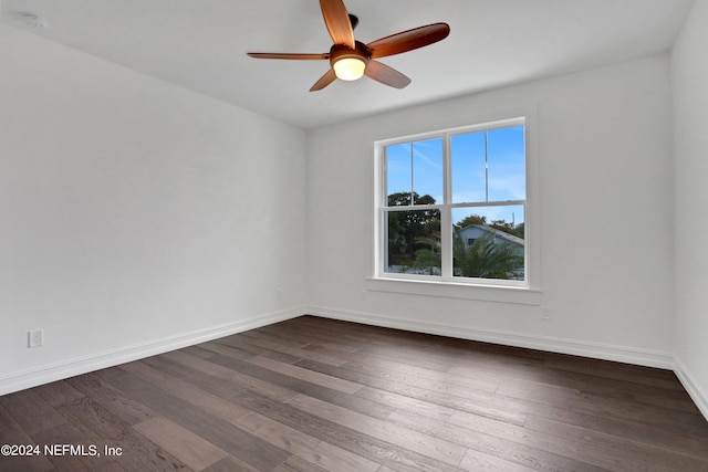 empty room with dark hardwood / wood-style flooring and ceiling fan