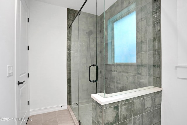 bathroom with tile patterned flooring and an enclosed shower