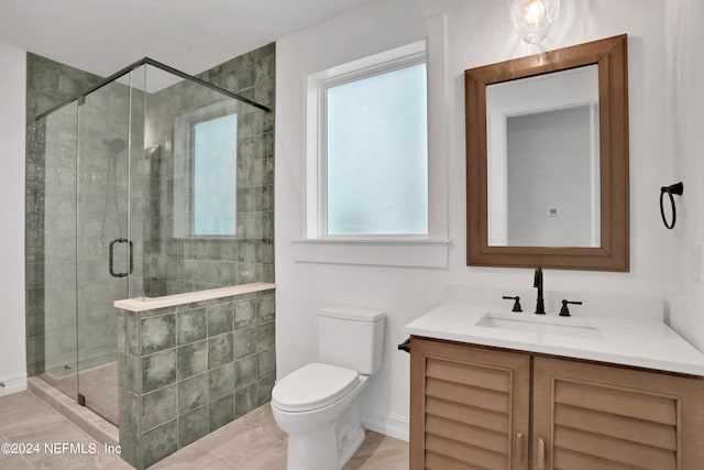 bathroom with vanity, tile patterned flooring, toilet, and an enclosed shower