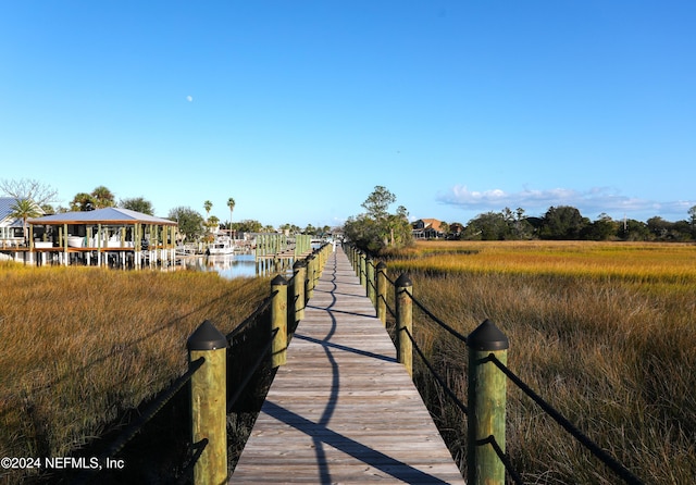 view of dock featuring a gazebo and a water view