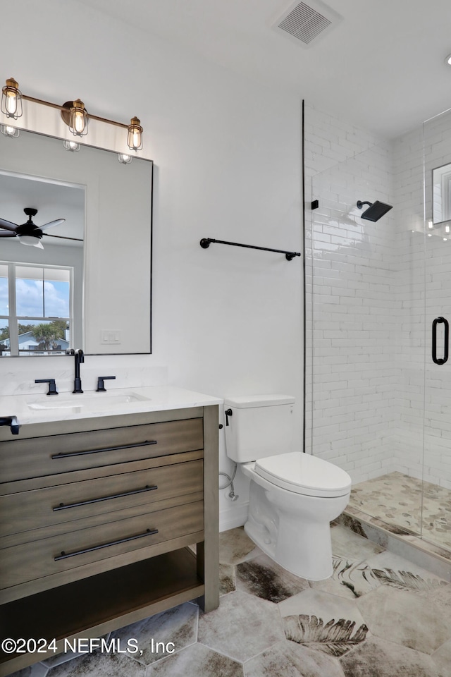 bathroom with walk in shower, vanity, toilet, and ceiling fan