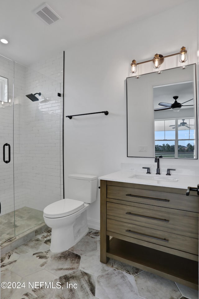 bathroom with vanity, toilet, and an enclosed shower