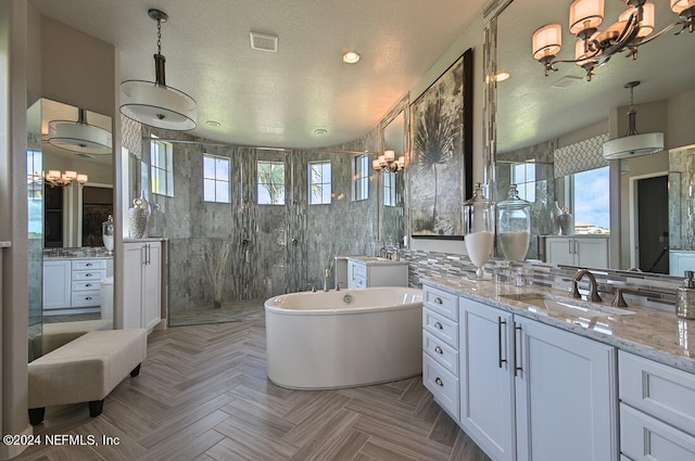 bathroom featuring vanity, shower with separate bathtub, tile walls, parquet floors, and a notable chandelier