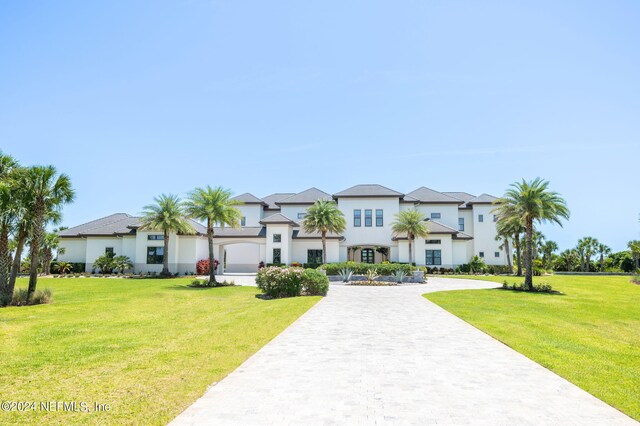 view of front of house with a front yard and a garage